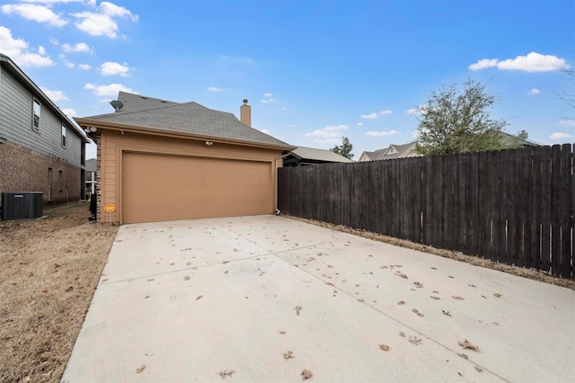 garage featuring cooling unit and fence