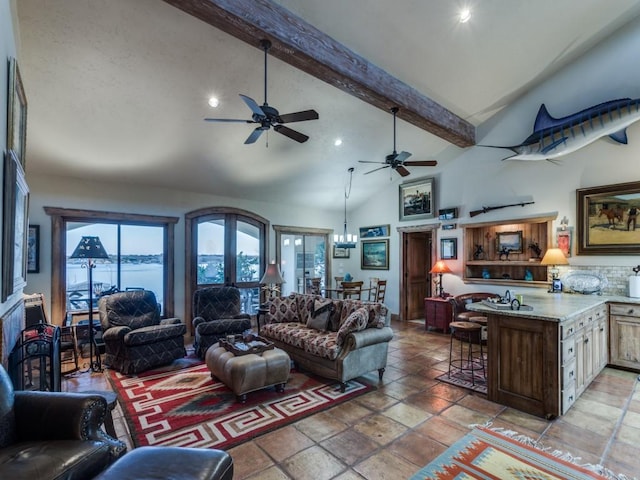 living area with recessed lighting, beamed ceiling, high vaulted ceiling, and ceiling fan with notable chandelier