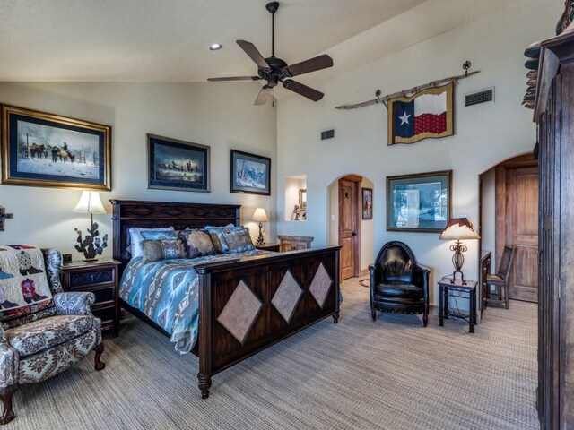 carpeted bedroom featuring visible vents, arched walkways, high vaulted ceiling, and ceiling fan