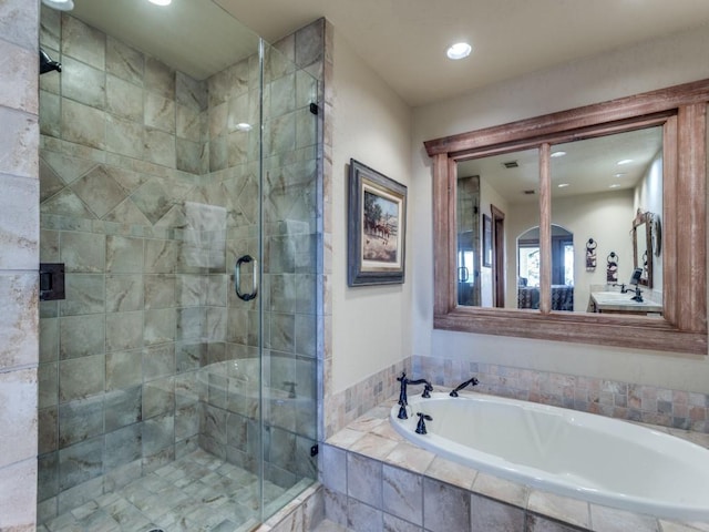 bathroom featuring recessed lighting, a stall shower, and a garden tub