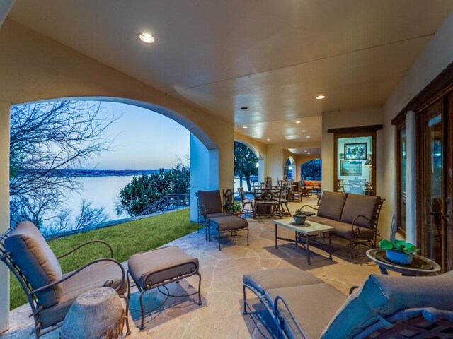 view of patio / terrace featuring outdoor dining area, an outdoor hangout area, and a water view