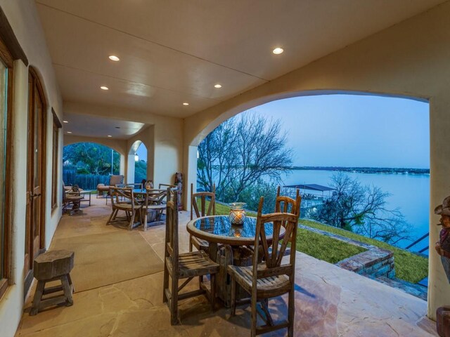 view of patio / terrace featuring outdoor dining space and a water view