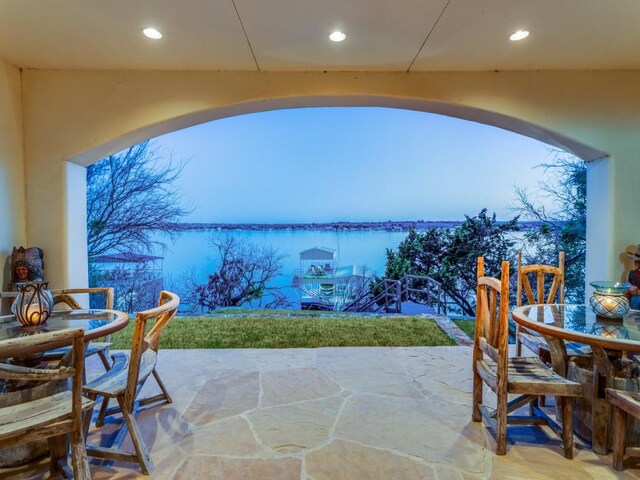 view of patio featuring outdoor dining space and a water view