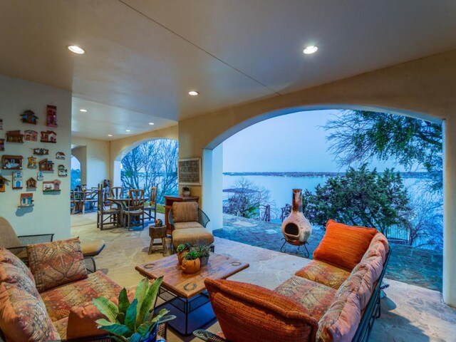 view of patio / terrace with outdoor dining area, a water view, and outdoor lounge area