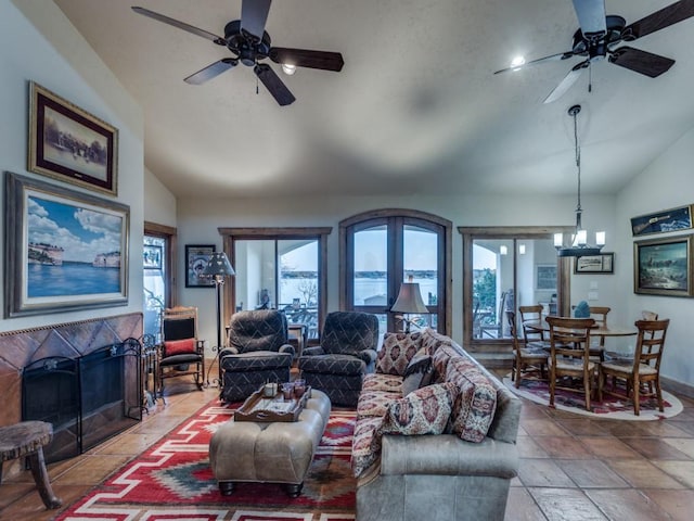 living room featuring a fireplace, lofted ceiling, and a healthy amount of sunlight