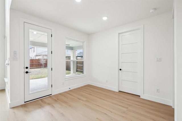 entryway featuring recessed lighting, baseboards, and light wood-style flooring