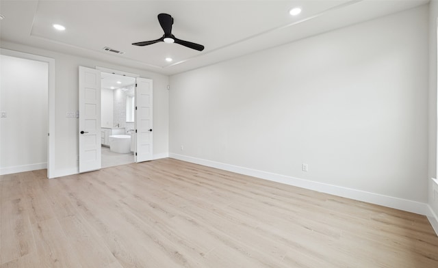 unfurnished bedroom with visible vents, baseboards, recessed lighting, light wood-style flooring, and ensuite bath