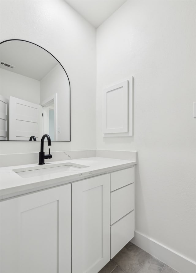 bathroom featuring vanity, visible vents, and baseboards