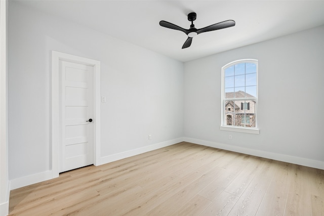 spare room with ceiling fan, baseboards, and wood finished floors