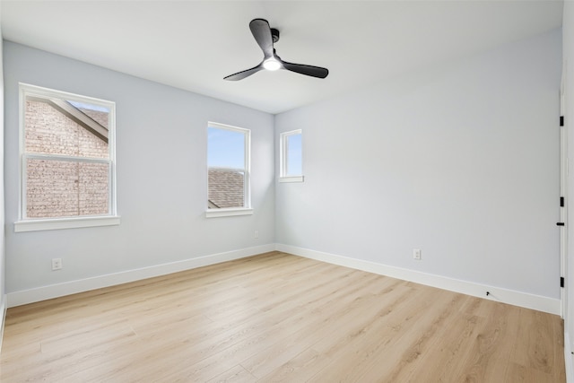 unfurnished room with wood finished floors, baseboards, and ceiling fan