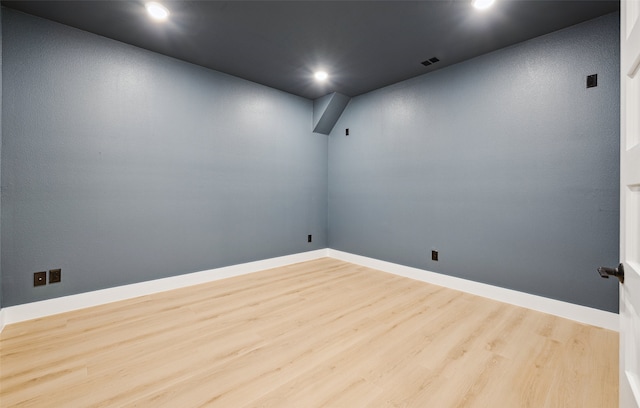 unfurnished room with recessed lighting, visible vents, baseboards, and wood finished floors