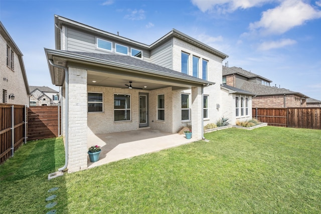 back of property with a patio area, a lawn, a fenced backyard, and ceiling fan