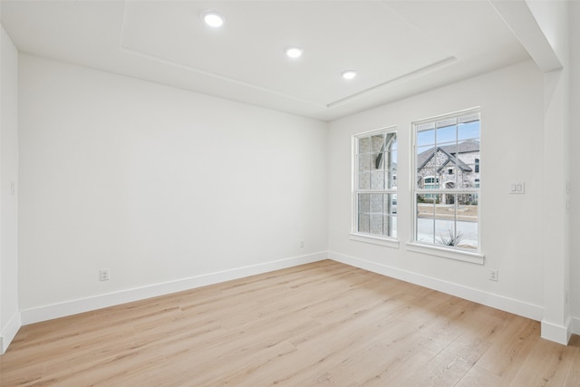 unfurnished room featuring recessed lighting, baseboards, and light wood-style floors