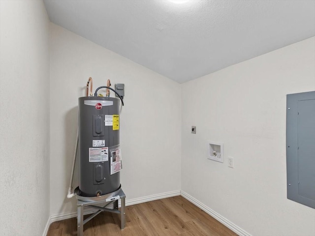 utility room featuring electric panel and water heater