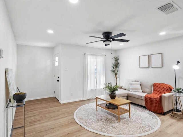 living room with recessed lighting, light wood-style floors, visible vents, and baseboards