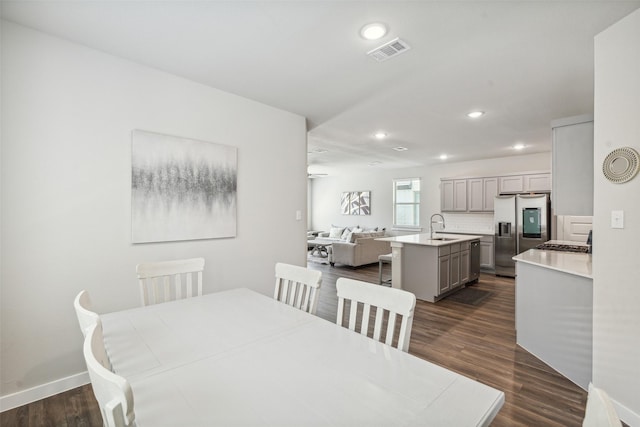 dining space featuring recessed lighting, visible vents, baseboards, and dark wood finished floors