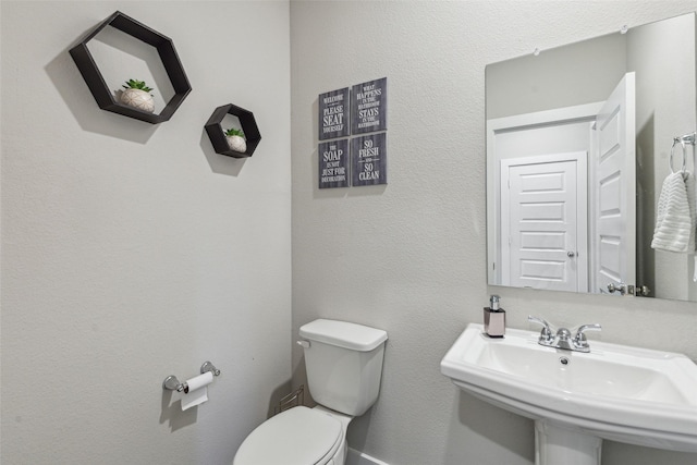 bathroom featuring toilet and a sink