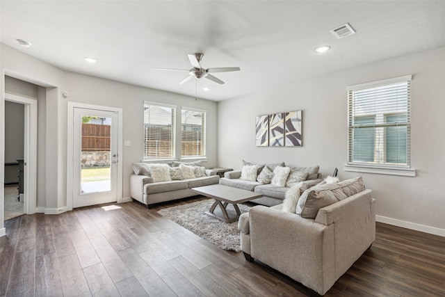 living area with recessed lighting, visible vents, baseboards, and dark wood finished floors