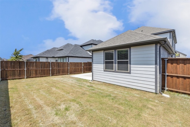 view of yard featuring a patio area and a fenced backyard