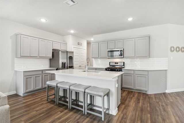 kitchen with a sink, gray cabinetry, visible vents, and stainless steel appliances