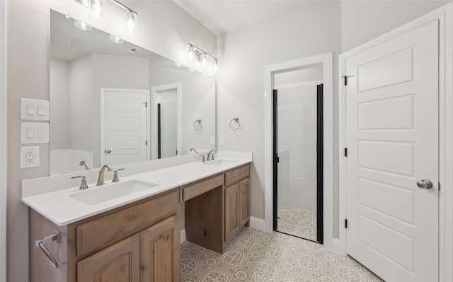 bathroom featuring double vanity, tile patterned floors, tiled shower, and a sink