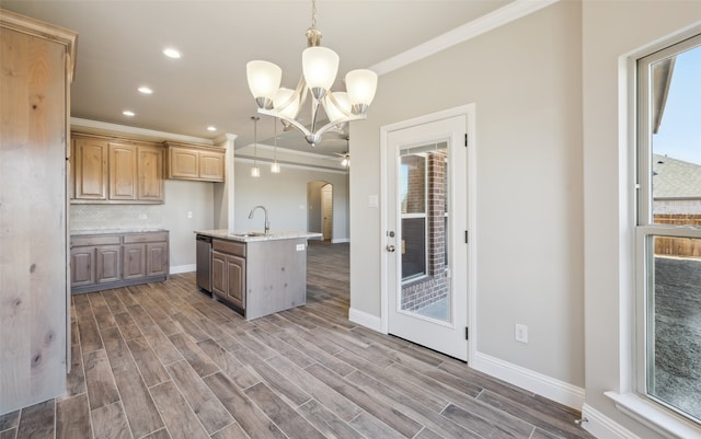 kitchen with a sink, backsplash, stainless steel dishwasher, arched walkways, and wood tiled floor