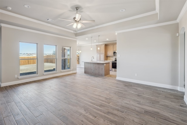 unfurnished living room with light wood-style flooring, baseboards, and ceiling fan