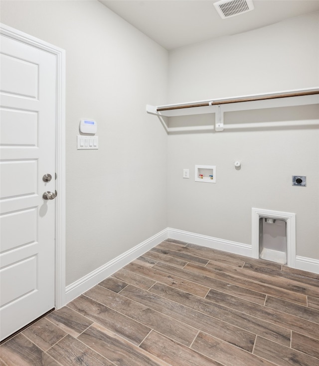 washroom with wood finish floors, visible vents, gas dryer hookup, and laundry area