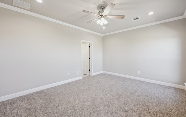 unfurnished room with visible vents, carpet floors, baseboards, and ornamental molding