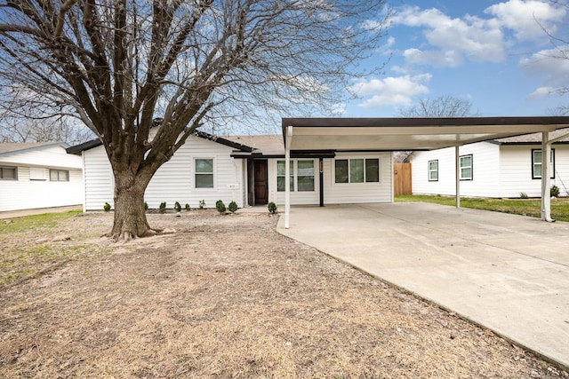 ranch-style home with a carport and concrete driveway