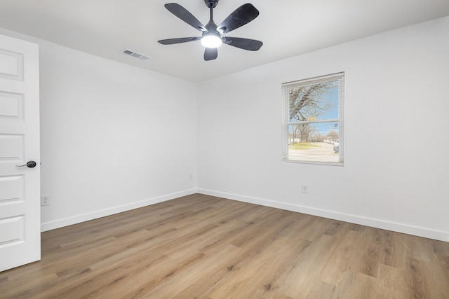 unfurnished room with light wood-type flooring, visible vents, baseboards, and a ceiling fan