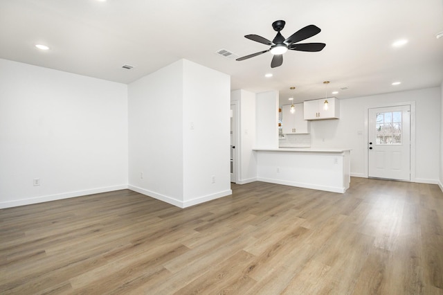 unfurnished living room with recessed lighting, visible vents, and light wood-style flooring