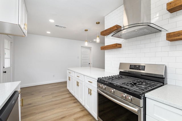 kitchen featuring open shelves, visible vents, appliances with stainless steel finishes, and wall chimney range hood