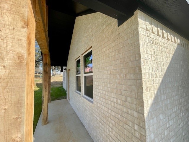 view of side of property with brick siding