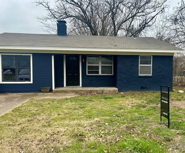 single story home featuring a porch, a front yard, crawl space, brick siding, and a chimney