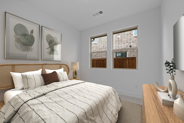 carpeted bedroom with baseboards and visible vents