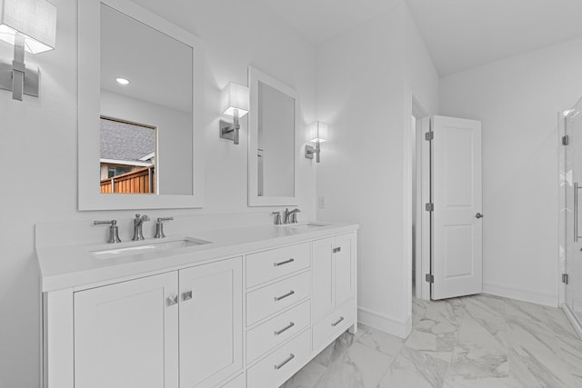 bathroom with double vanity, baseboards, marble finish floor, and a sink