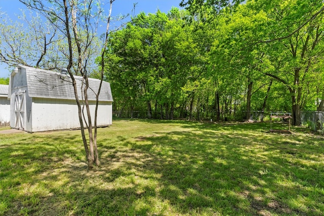 view of yard featuring an outbuilding, a fenced backyard, and a shed
