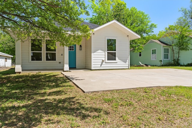rear view of property featuring a yard
