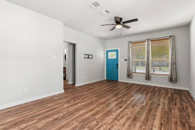 foyer featuring visible vents, baseboards, a ceiling fan, and wood finished floors