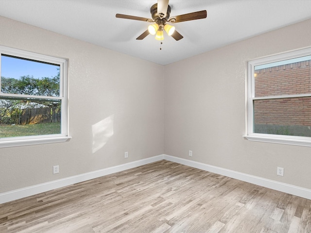 spare room with ceiling fan, baseboards, and wood finished floors