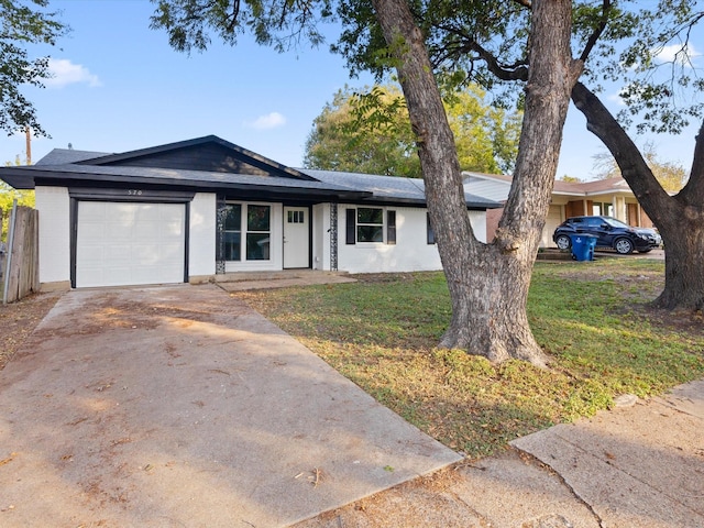 ranch-style house with brick siding, driveway, an attached garage, and a front yard