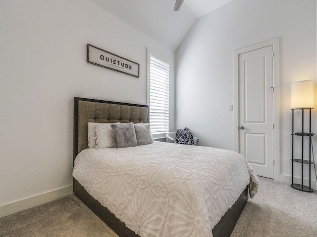 bedroom with vaulted ceiling, ceiling fan, baseboards, and carpet floors