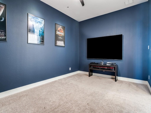 carpeted home theater featuring visible vents, a ceiling fan, and baseboards