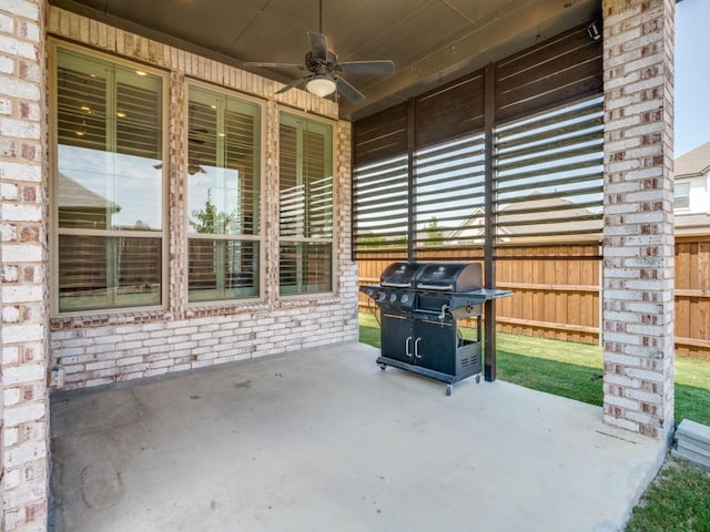 view of patio featuring grilling area, a ceiling fan, and fence