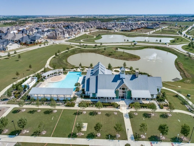 drone / aerial view featuring a water view and a residential view