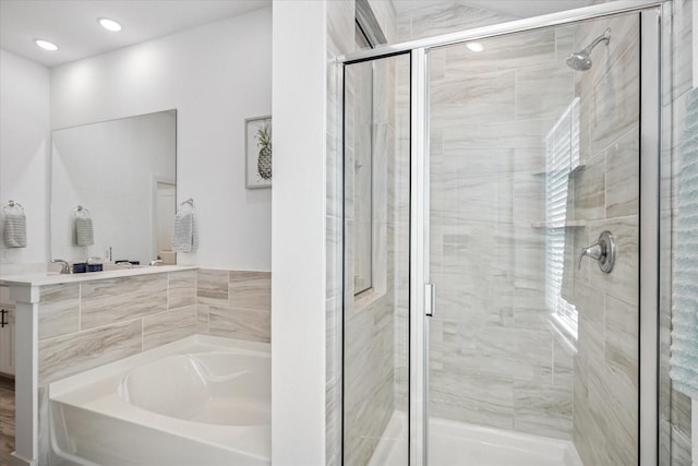 full bath featuring recessed lighting, vanity, a garden tub, and a shower stall