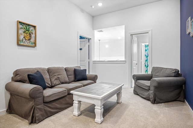 carpeted living area featuring visible vents