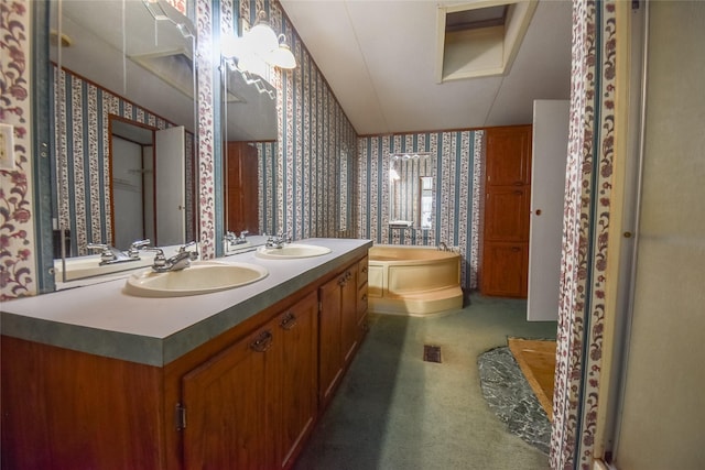 full bathroom featuring a sink, a bath, double vanity, and wallpapered walls