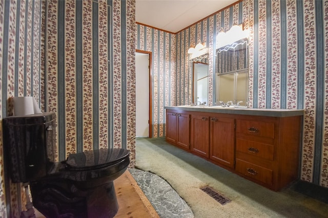 full bathroom featuring visible vents, vanity, wallpapered walls, and crown molding